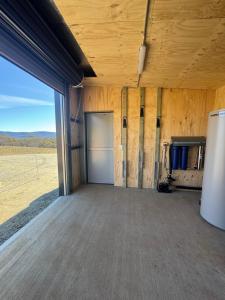 a room with a garage with a large window at Wuelf & the Fallow in Moonbah +20 photos