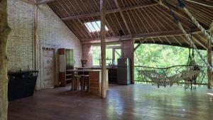 a large room with a kitchen and a living room at Seed Village in Sekongkang