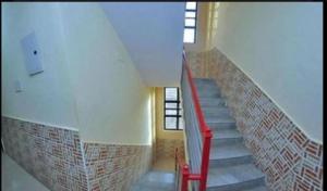 a staircase in a building with a red railing at Sai bhagwan budget hotel in Shirdi