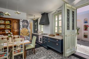 a kitchen with a table and a dining room at Siliguri Traditional House in Rhodes Town
