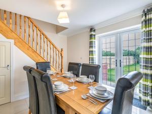 a dining room with a wooden table and chairs at Dawson Park 9 - Uk12668 in Mablethorpe