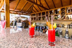two red cocktails sitting on a counter in a bar at Hotel Aqua in Marmaris