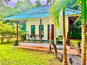 a small house with a porch and a table at Tropical Paradise Leelawadee Resort in Ko Chang