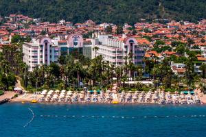 a view of a beach with umbrellas and a resort at Hotel Aqua in Marmaris
