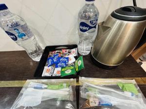 a table with two bottles of water and a tray of snacks at Hotel Jyoti Stay Inn 10 Min to Ram Tample in Ayodhya +86 photos