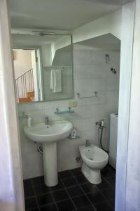 a bathroom with a sink and a toilet at Da Gina in San Gimignano