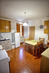 a kitchen with a table and chairs and a kitchen with a table and a kitchen at Da Gina in San Gimignano
