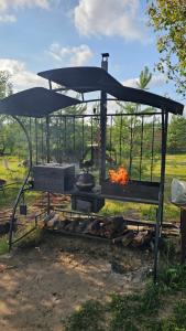 an outdoor grill with a stove and a fire at Green Hills Villa in Sakhnovka