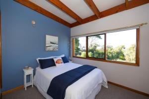 a bedroom with a large bed and a window at The Avenue in Anglesea