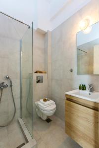 a bathroom with a shower and a toilet and a sink at Aqua Marina in Rethymno Town