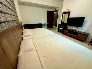 Łóżko lub łóżka w pokoju w obiekcie Cian Yuan B&B