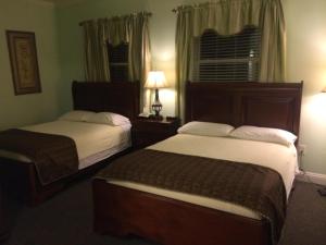 a hotel room with two beds and a window at The City Hotel Bar & Grill in Northern Cambria