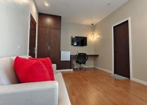 a living room with a white couch and a black chair at Ambien's Place Residential Hotel in Dagupan