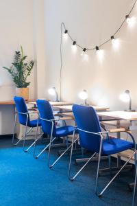 a conference room with blue chairs and a table at DS Za Kolumnami in Krakow