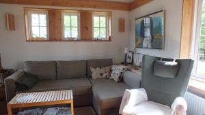 a living room with a couch and a table at Am See in Pastin