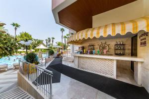 a bar at a resort with a swimming pool at Hotel Aqua in Marmaris