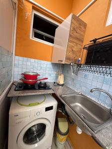 a kitchen with a washing machine and a sink at Kobuleti Central in Kobuleti +24 photos