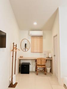 a bathroom with a table and a chair and a mirror at LAIWAII HOME in Hat Yai +183 photos