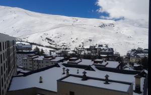 a view of a snow covered mountain from a city at Fuente del Tesoro Apartment in Granada +9 photos