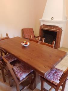 a dining room table with chairs and a fireplace at La Casa nel Bosco Rocchetta a Volturno in Rocchetta a Volturno +16 photos