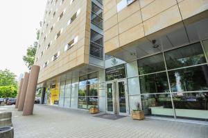 a large building with glass doors on a street at DS Za Kolumnami in Krakow
