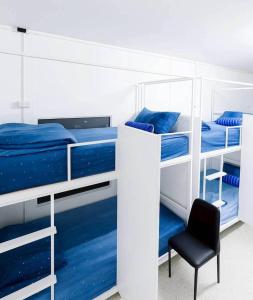 a bedroom with two bunk beds with a chair at Sleepymoon Hostel in Thongsala +64 photos