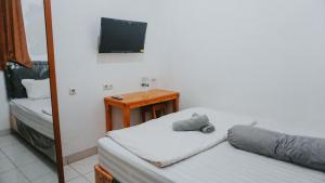 Postel nebo postele na pokoji v ubytování NamRoom at Tomang