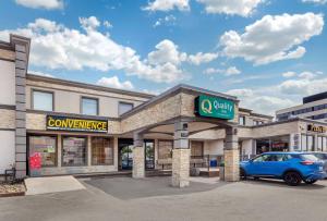 a car parked in front of a convenience store at Quality Inn Toronto Airport in Mississauga