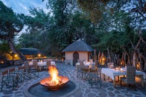 un foyer avec tables et chaises et un gazebo dans l'établissement Tuli Safari Lodge Mashatu, à Lentswelemoriti