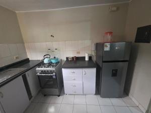 a small kitchen with a stove and a refrigerator at RODRICH apartment 2 in Lima