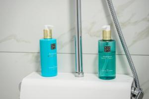 two bottles ofodorizers sitting on a shelf in a bathroom at Boutique rooms Kican in Metković +59 photos