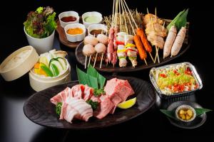 three plates of food on a table with different foods at SUKH Hakuba Chalet by Jade Villa in Hakuba