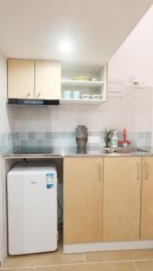 a kitchen with a white refrigerator in a room at FFC sweet home on Shaanxi Road in Shanghai +6 photos