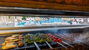 a grill with different types of food on it at Hotel Aqua in Marmaris