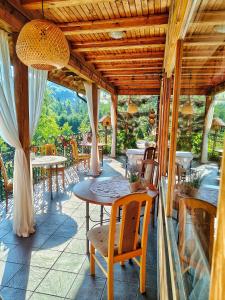 an outdoor patio with tables and chairs and a table and chairs at Czarna Owca in Istebna