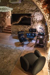 a living room with chairs and a fireplace at Nomadic Urban Premium Suites in Krakow