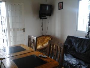 a dining room table with a cat in a chair at Cabañas Del Sol in Las Compuertas