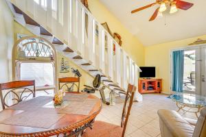 a living room with a table and a staircase at Cheerful 1-bedroom townhouse with spacious loft in Panama City Beach