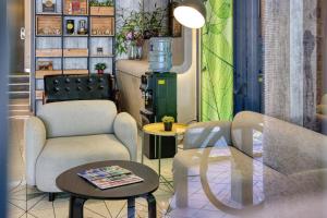 a living room with two chairs and a table at Hmlet Essentials Clarke Quay in Singapore