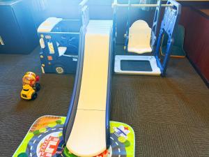 a childs play room with a toy truck and a playset at Ikaho Kids Paradise Hotel - Vacation STAY 56072v in Shibukawa