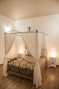 a bedroom with a bed with a canopy at campo appartamenti in Trapani