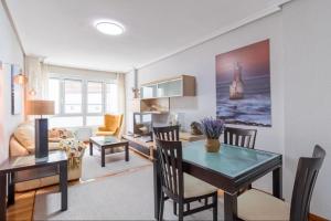 a living room with a table and a dining room at San vicente centro l 1000 metros playas in San Vicente de la Barquera