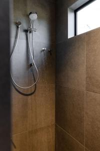 a shower in a bathroom with a window at Villa 3 - Greenstone Villas in St Helens +14 photos