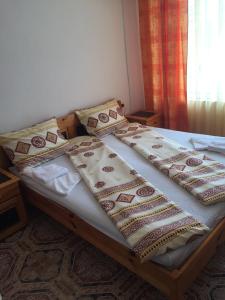 a bed with four pillows on it in a bedroom at Complex Laguna-Kantardzhiev in Primorsko +49 photos