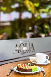 a plate of cake and a cup of coffee on a table at Hotel Aqua in Marmaris