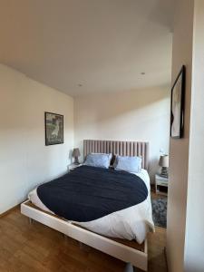 a bedroom with a large bed with a black blanket at Quiet flat center Monaco in Monte Carlo