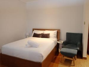 a bed and a chair in a small room at Number 29 Adelaide Street in Fremantle