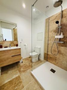 a bathroom with a shower and a toilet and a sink at Ti Marie Ly in Audierne