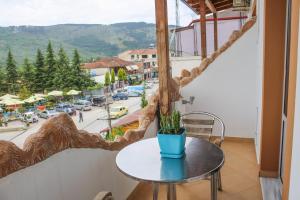 a table in a room with a view of a street at Hotel Shpella in Berat