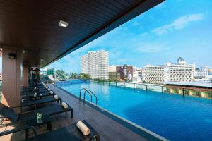 a large swimming pool on top of a building at Acqua Hotel in Pattaya Central